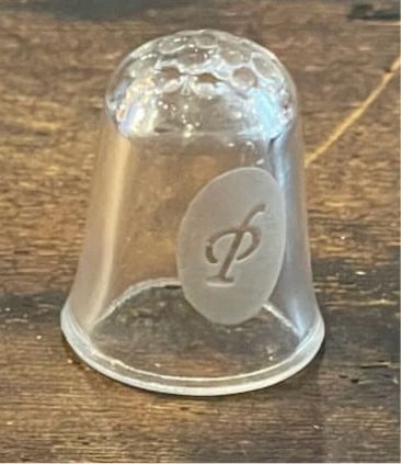 Glass thimble engraved with “P”