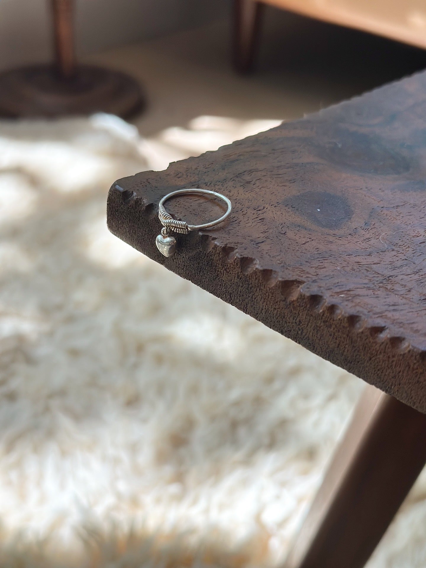 Delicate sterling silver ring with hanging heart
